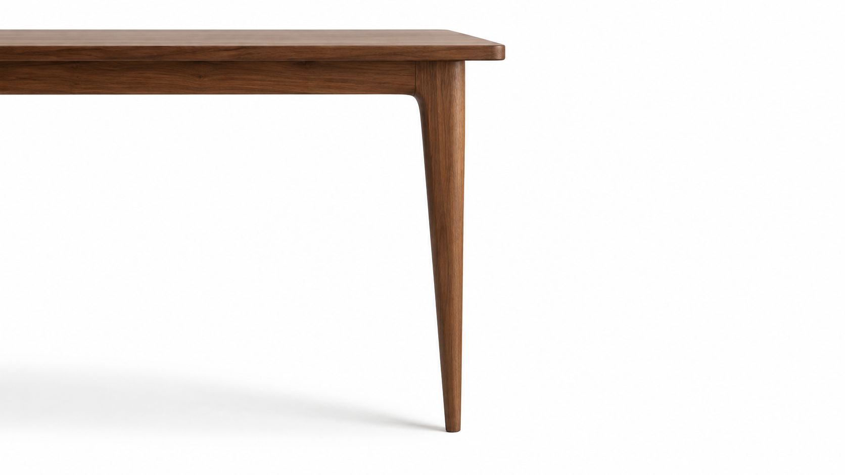 A close-up shot showing the sleek, tapered wooden leg and smooth top corner of a dining table.
